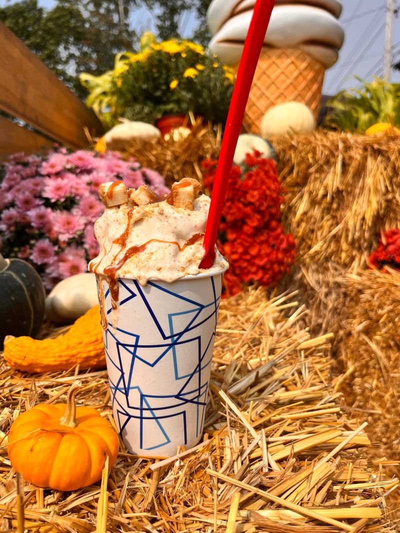 Pumpkin milkshake with caramel drizzle and fall decor
